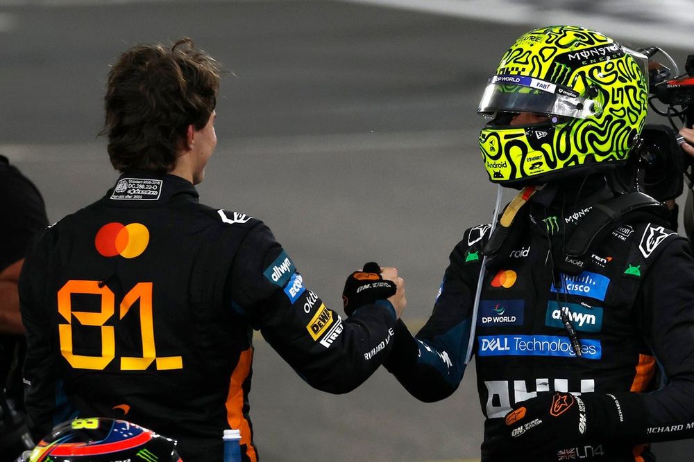 Lando Norris e Oscar Piastri, pilotos da McLaren, conversam em um paddock da Fórmula 1