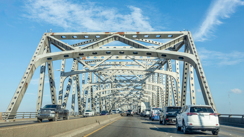 Detalhe de uma junta de expansão metálica em uma ponte, mostrando as placas e o espaço para movimento